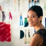 Portrait Of Happy Hispanic Young Woman Working As Fashion Design